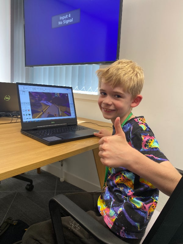 Primary school pupil enjoying Code Clock Summer School of Programming 2023